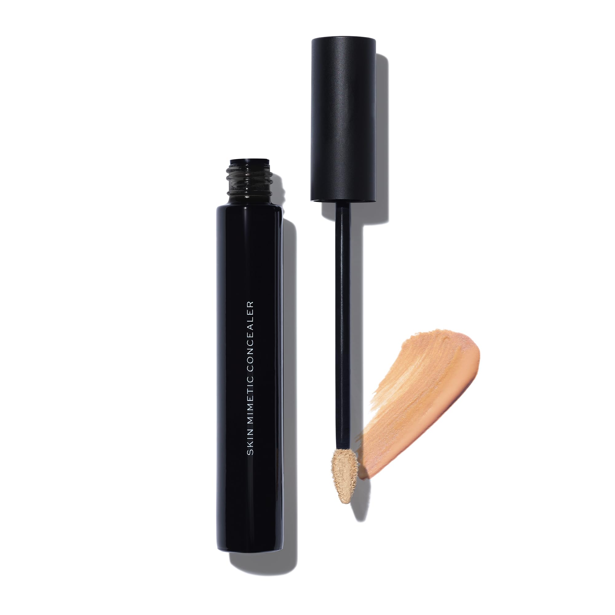 Full-coverage concealer bottle with brush applicator