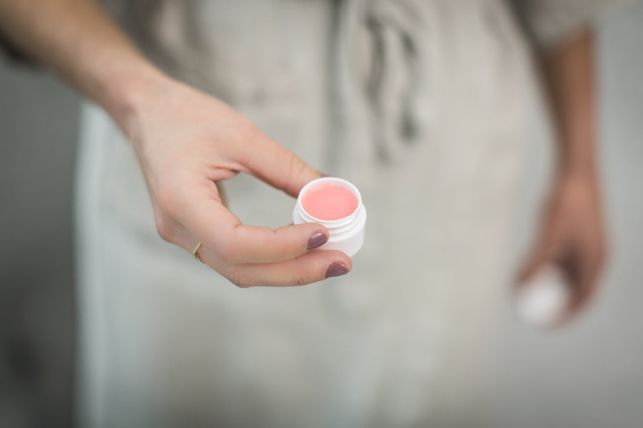 Open lip balm jar with a soft cream texture