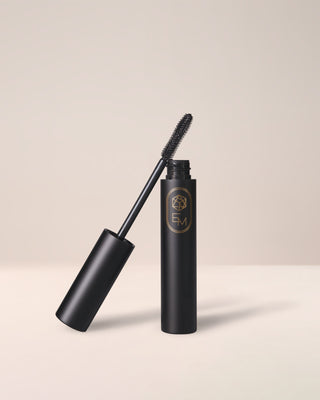 Curling mascara tube with a curved wand applicator