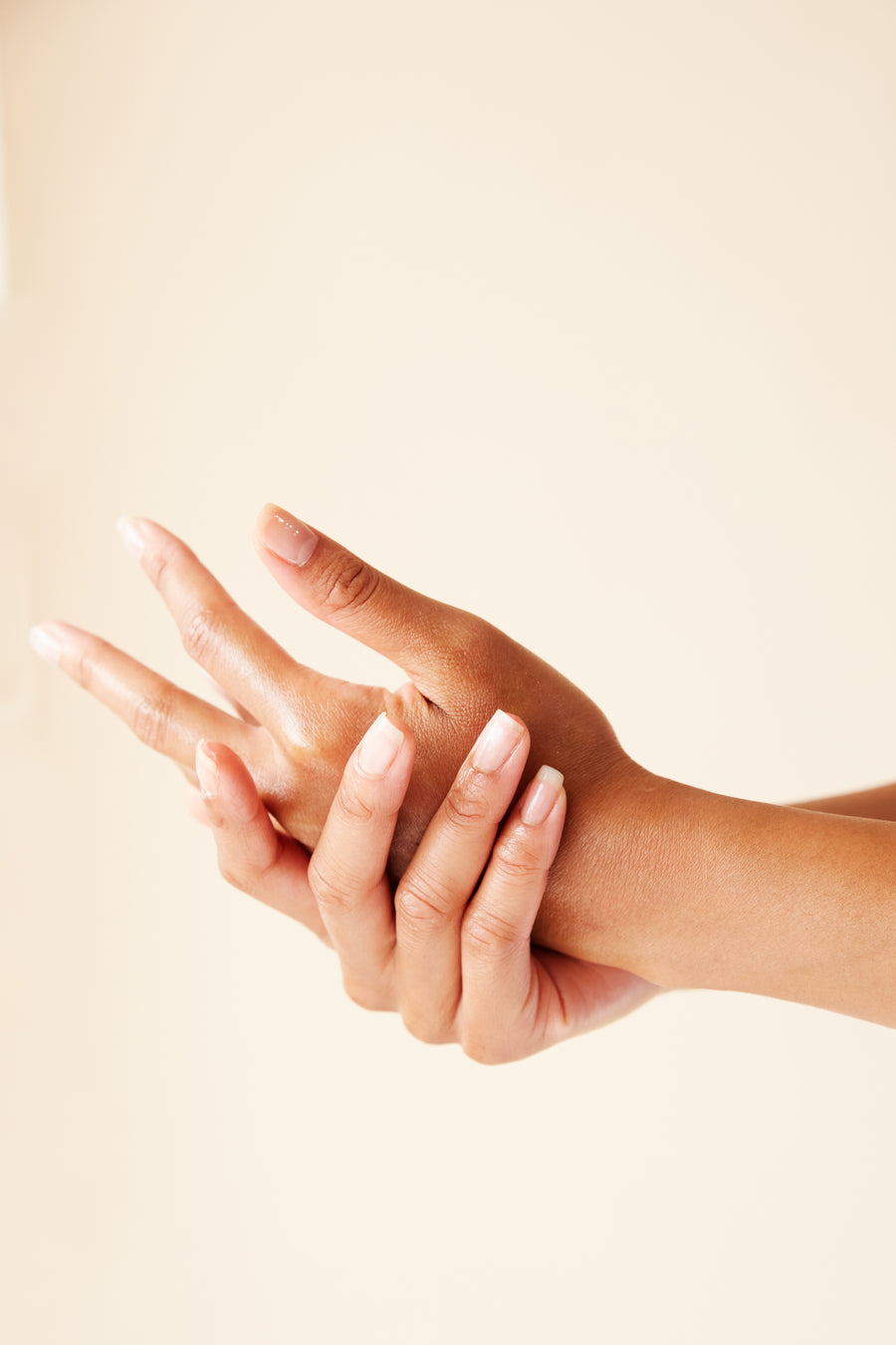 Hands performing a relaxing facial skincare treatment